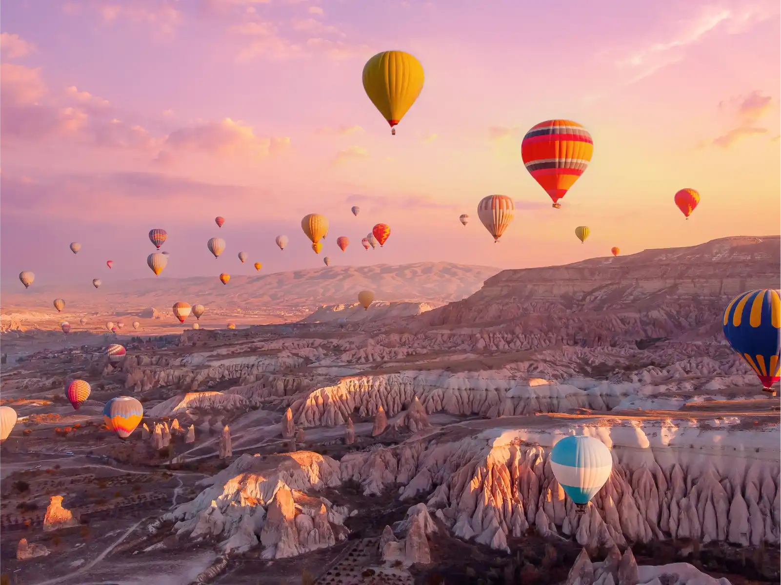 Hot air balloons over Cappadocia at sunrise